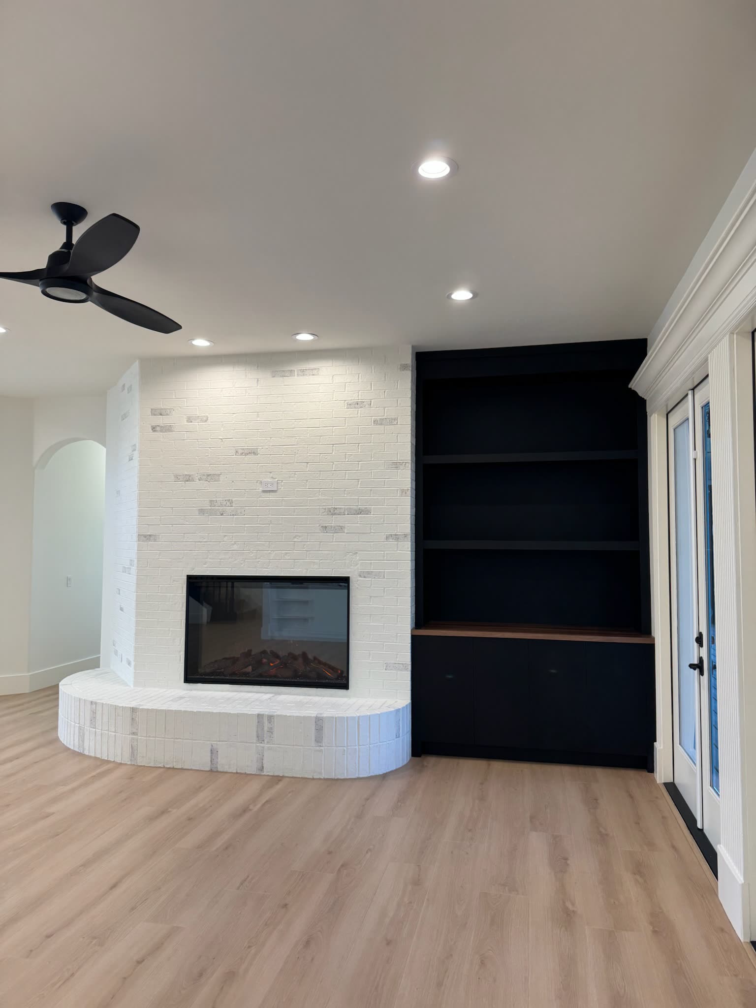 Rebuilt great room with plaster fireplace and custom shelving